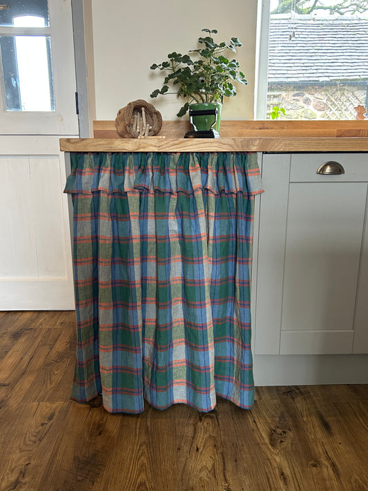 Forest green, blue and bright orange linen Gingham under counter curtain in the kitchen hiding the washing machine